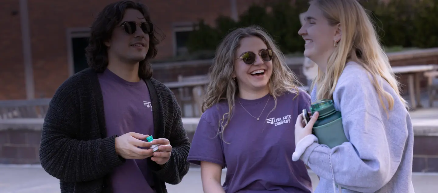 Students laughing near Denaples Center
